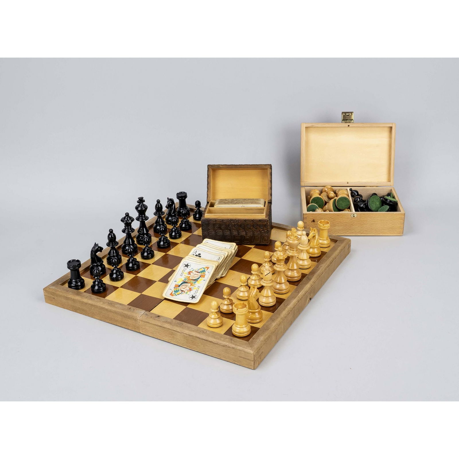 Chess set, 19th/20th century, 2 games: Chess set, 19th/20th century, 2 games with complete set of pieces. Including a carved box for playing cards (with cards). The large, older chess set with heavy damage. Up to 9 x 32 x 32 cm