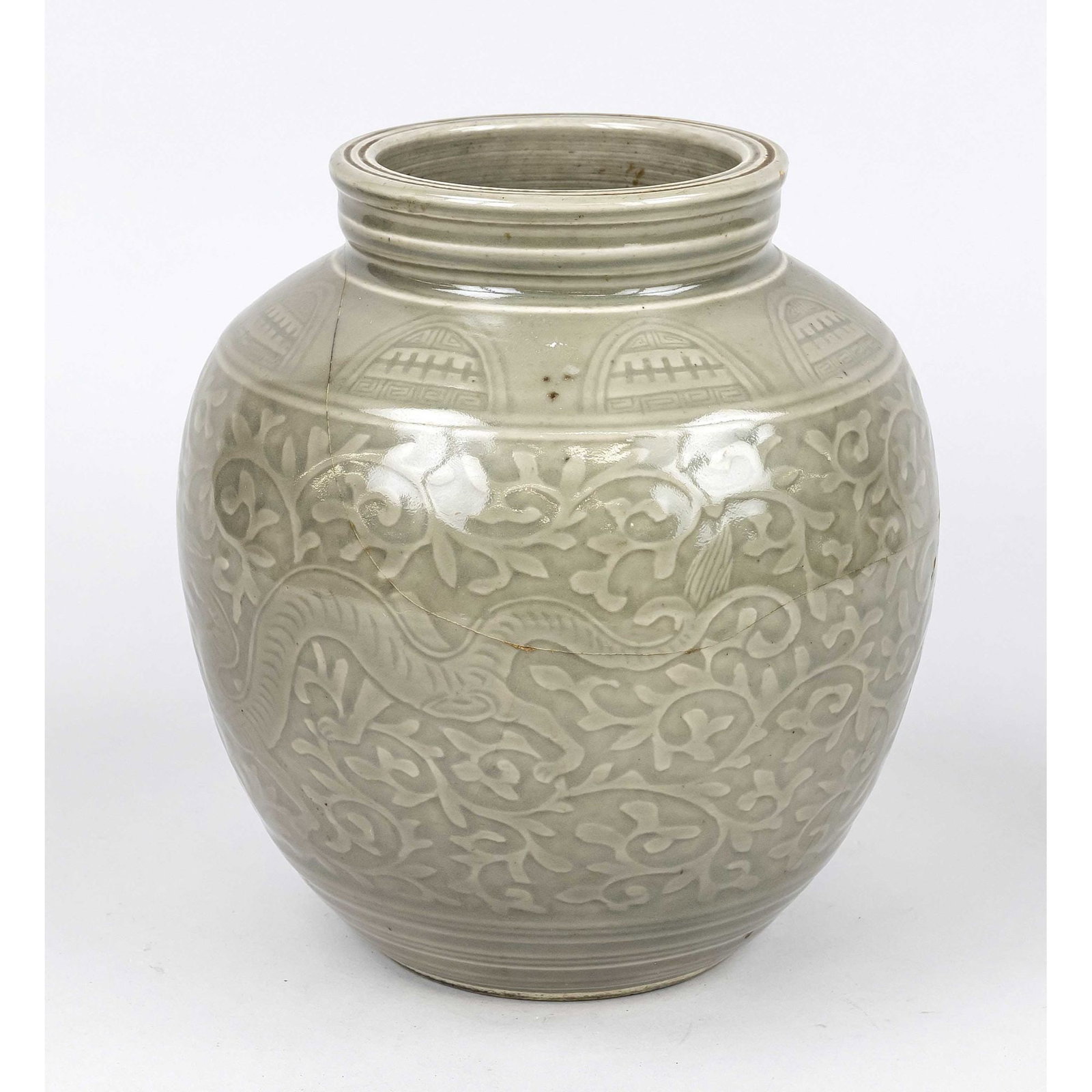 Yazhou ware pot, China, probably 18: Yazhou ware pot, China, probably 18th century, circumferential molded/cut decoration with dragons between lotus tendrils, monochrome (grey-green/seladon) glaze, glued, h. 24.5 cm