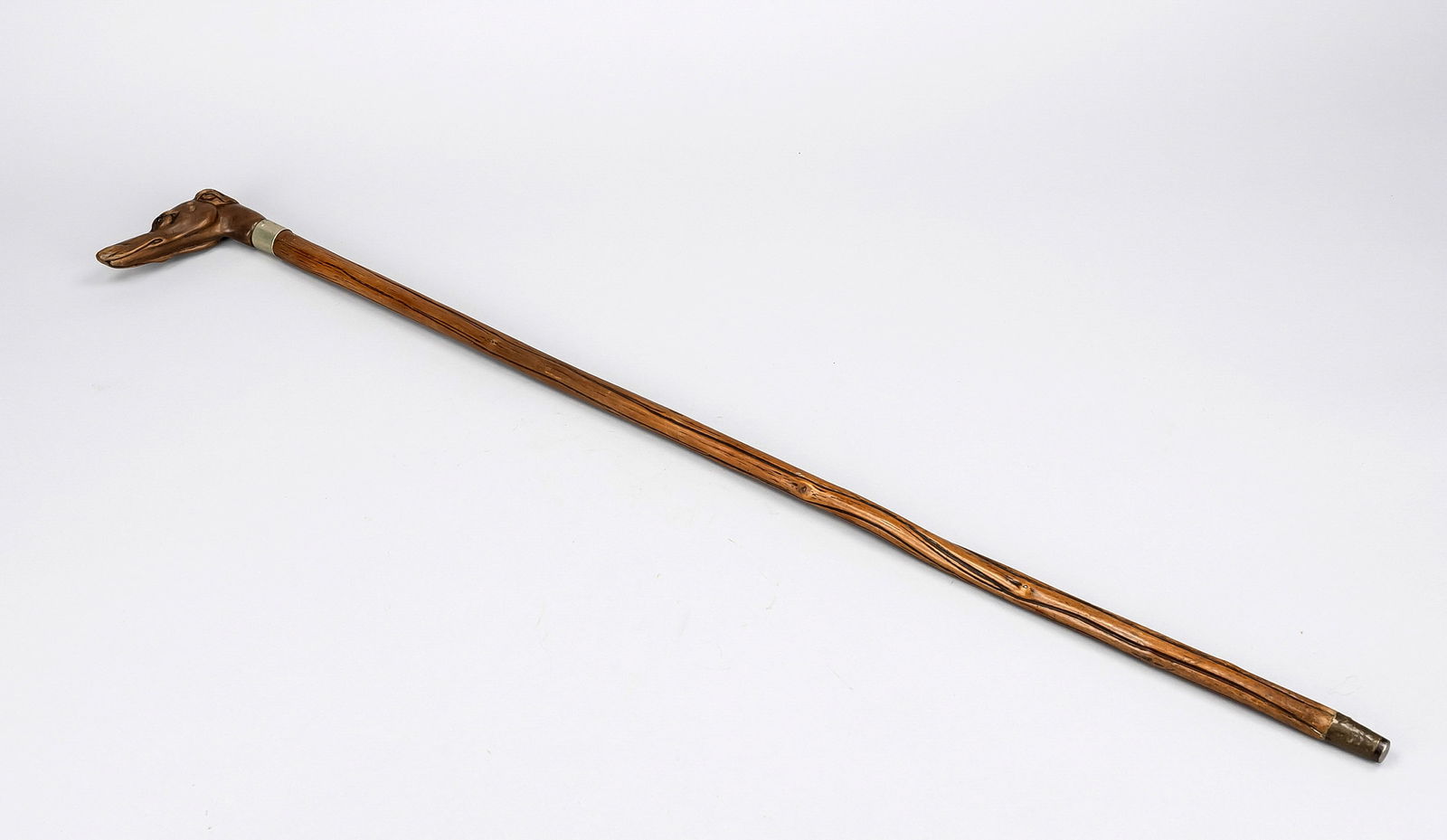 Walking stick, late 19th century, wood: Walking stick, late 19th century, wood with metal cuff, handle in the shape of a greyhound's head with glass eyes, finely executed, cuff with monogram engraving somewhat loose, rubbed l. 86 cm