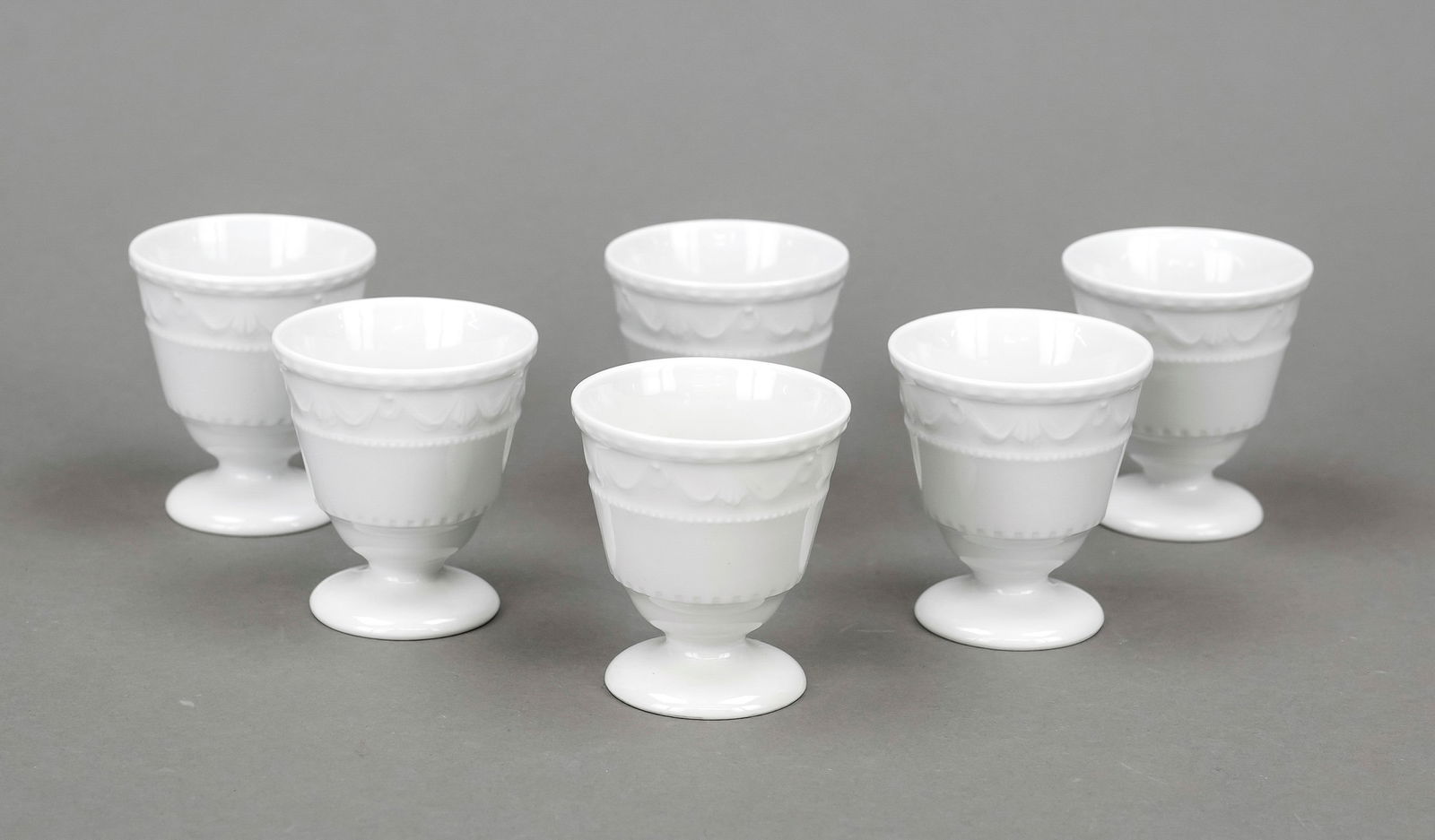Six egg cups, KPM Berlin, marks 1: Six egg cups, KPM Berlin, marks 1962-2000, majority 1st choice, Kurland form, designed for the last Duke of Courland c. 1790 by Friedrich Elias Meyer, white, h. 6 cm