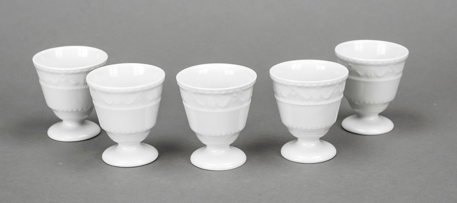 Five egg cups, KPM Berlin, marks: Five egg cups, KPM Berlin, marks 1962-2000, 1st choice, Kurland shape, design for the last Duke of Courland c. 1790 by Friedrich Elias Meyer, white, h. 6 cm