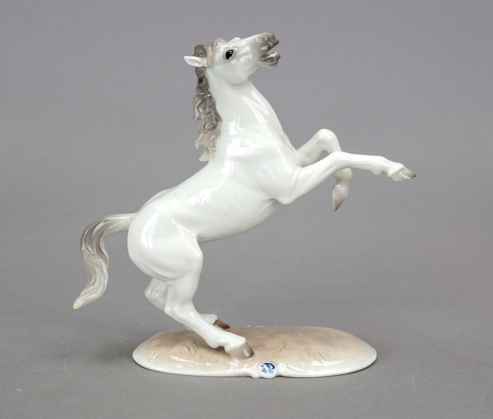 Climbing stallion, Nymphenburg, 2: Climbing stallion, Nymphenburg, 2nd half of the 20th century, designed by August Göhring around 1930, monogrammed, model no. 800a, on an oval plinth, naturalistically painted, h. 16 cm