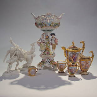 Grouping of Porcelain Objects: A hand painted Viennese partial tea set circa 19th century. A Dresden centerpiece surrounded by colorful flowers and two 19th century figures of a man and woman. Pair of bisque figures of ballerina