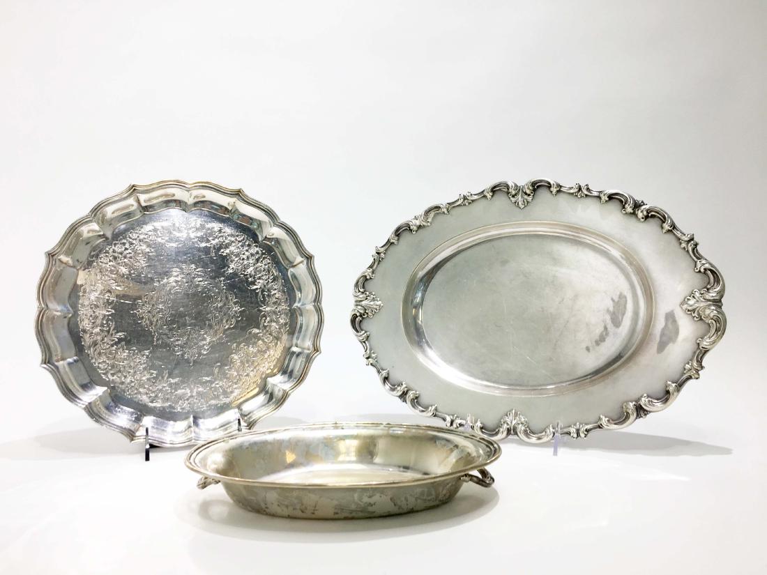 Three Silver Platters of Various Makers: Three silver platters of various makers. Two of sterling one marked 812. Longest width 15 in. Weight: 2080g. Property from the Estate of Jane Rothschild ***Update June 8, 2018. Please note that the we