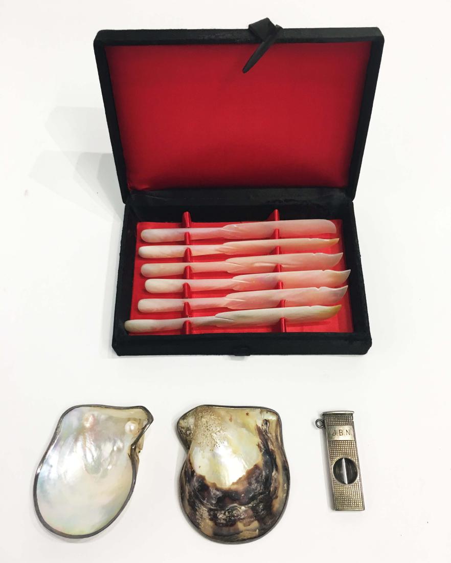 Mother of Pearl Caviar Knives & Silver Cigar Cutter: Two silver lined mother of pearl oyster shells and a set of mother of pearl caviar knives and silver cigar cutter with monogram. Property from the Estate of Jane Rothschild