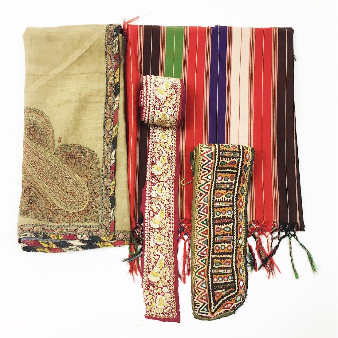 Lot of 4 Indian Embroidered and Syrian Textiles: Comprised of a Kashmiri embroidered square panel. A long embroidered border of an Indian Sari. A Syrian Striped silk textile and an Indian cloth with mirrors.