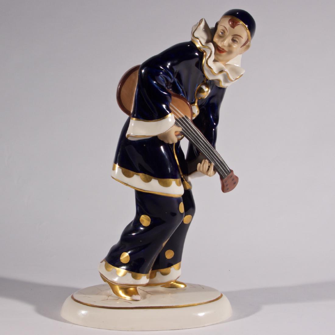 Royal Dux Signed Harlequin Guitar Player: Jester playing a guitar. Made in Czechoslovakia. Makers mark on bottom. Height 14 inches.
