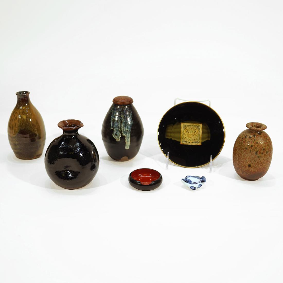 Lot of Japanese Ceramics with East Fish Chopsticks Rest: Seven Japanese ceramics with East fish chopsticks rest. Tallest vase height 6 inches. Black plate diameter 6 inches.