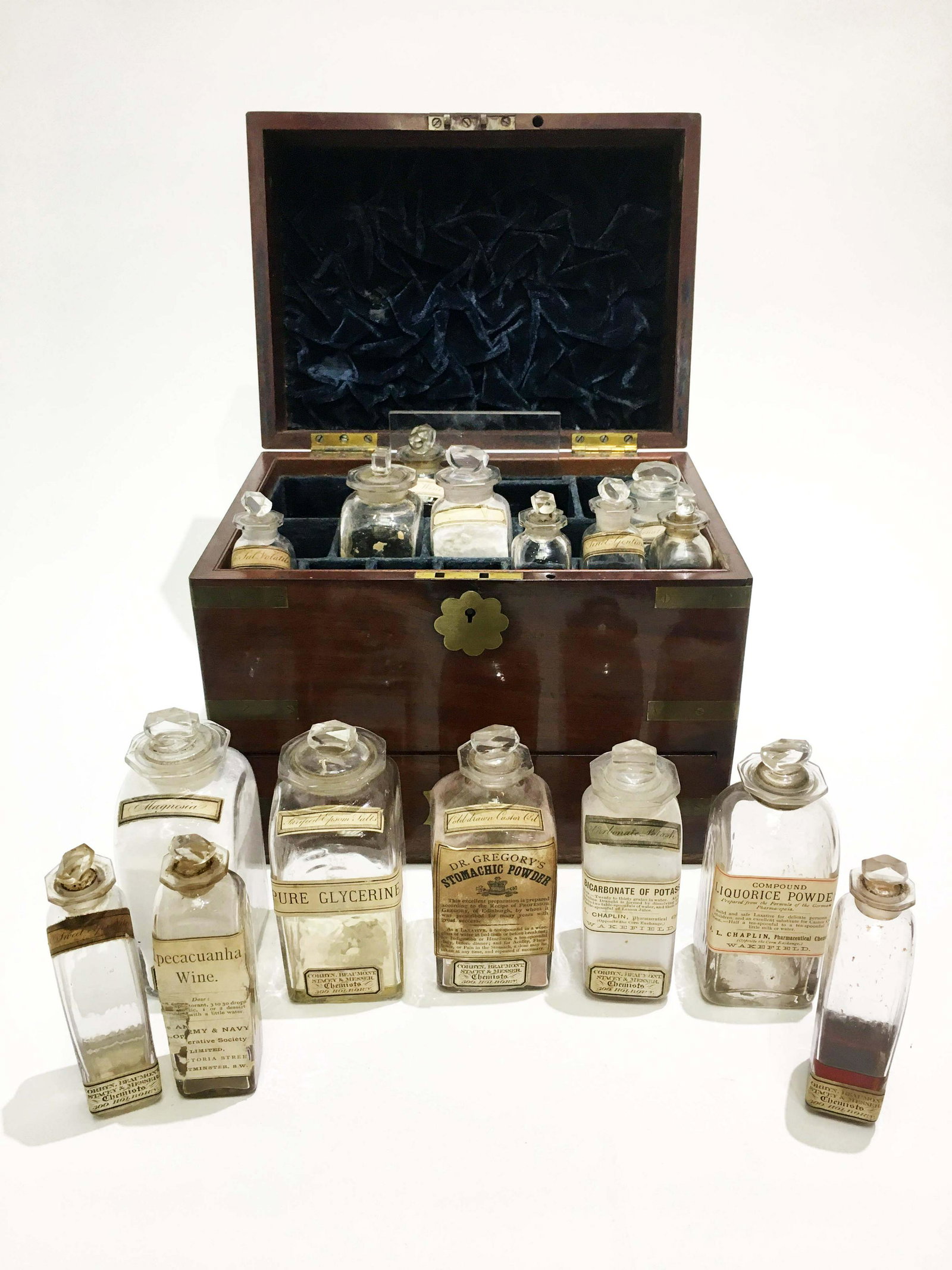Antique English Mahogany Medicine Chest / Apothecary: Antique English mahogany medicine chest. Brass bound. Early 19th century. Retractable drawers and sliding covers over part of the drawer. Original glass jars with medicine and scale with weights. 11.5