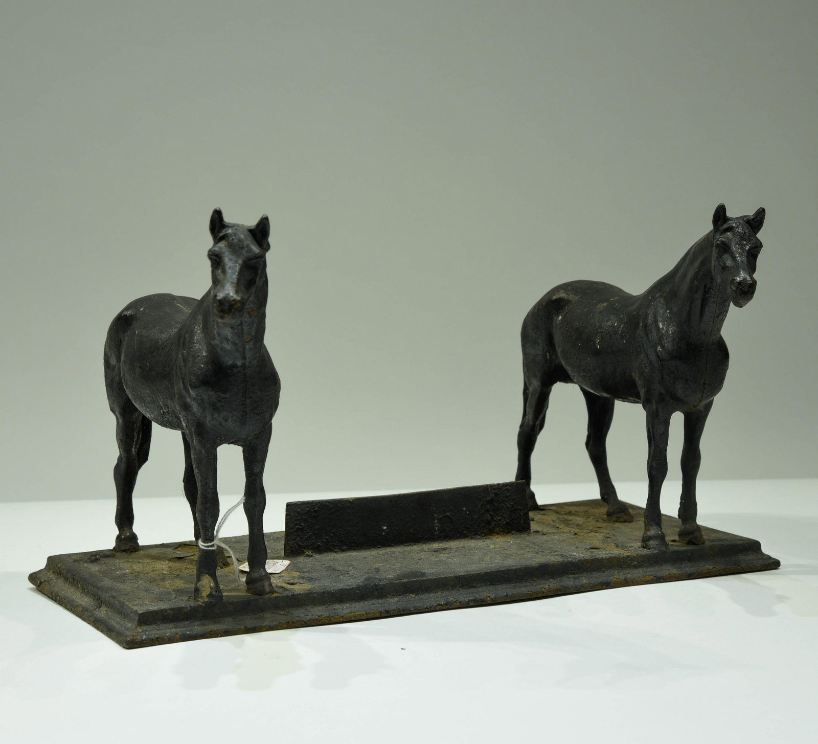 Cast-Iron Equestrian 19th Century Boot Scraper: A cast iron equestrian boot scraper with two standing horses on either side of the scraper. England 19th century. Height 7 in x Length 17 in x width 7 in