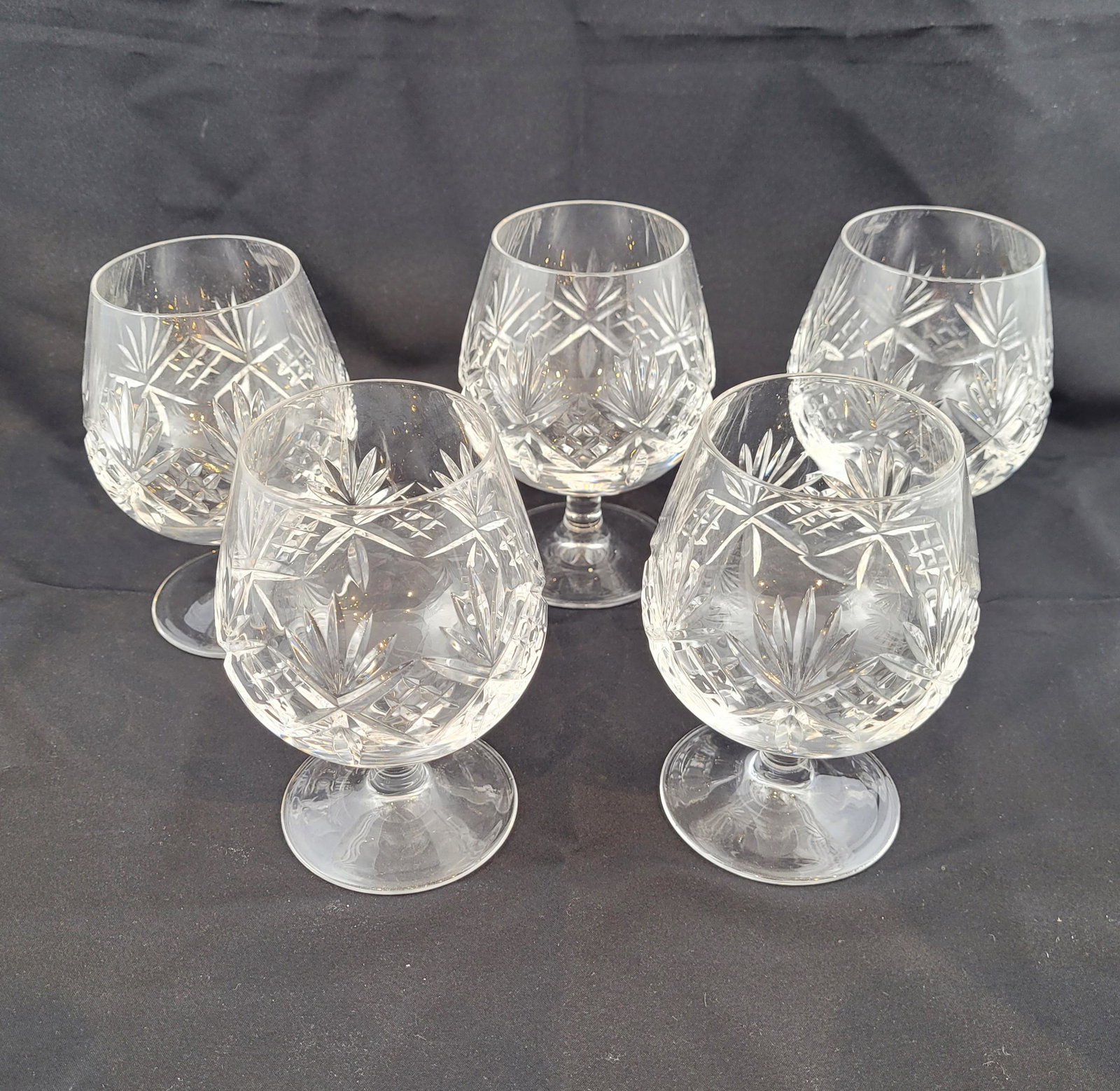 Five Tiffany & Co, Stemmed Wine Glasses: Five Tiffany cut glass stemmed wine glasses. each marked Tiffany & Co. Height 5 inches. Property from the estate of Dr. Nafis Sadik, no reserve.