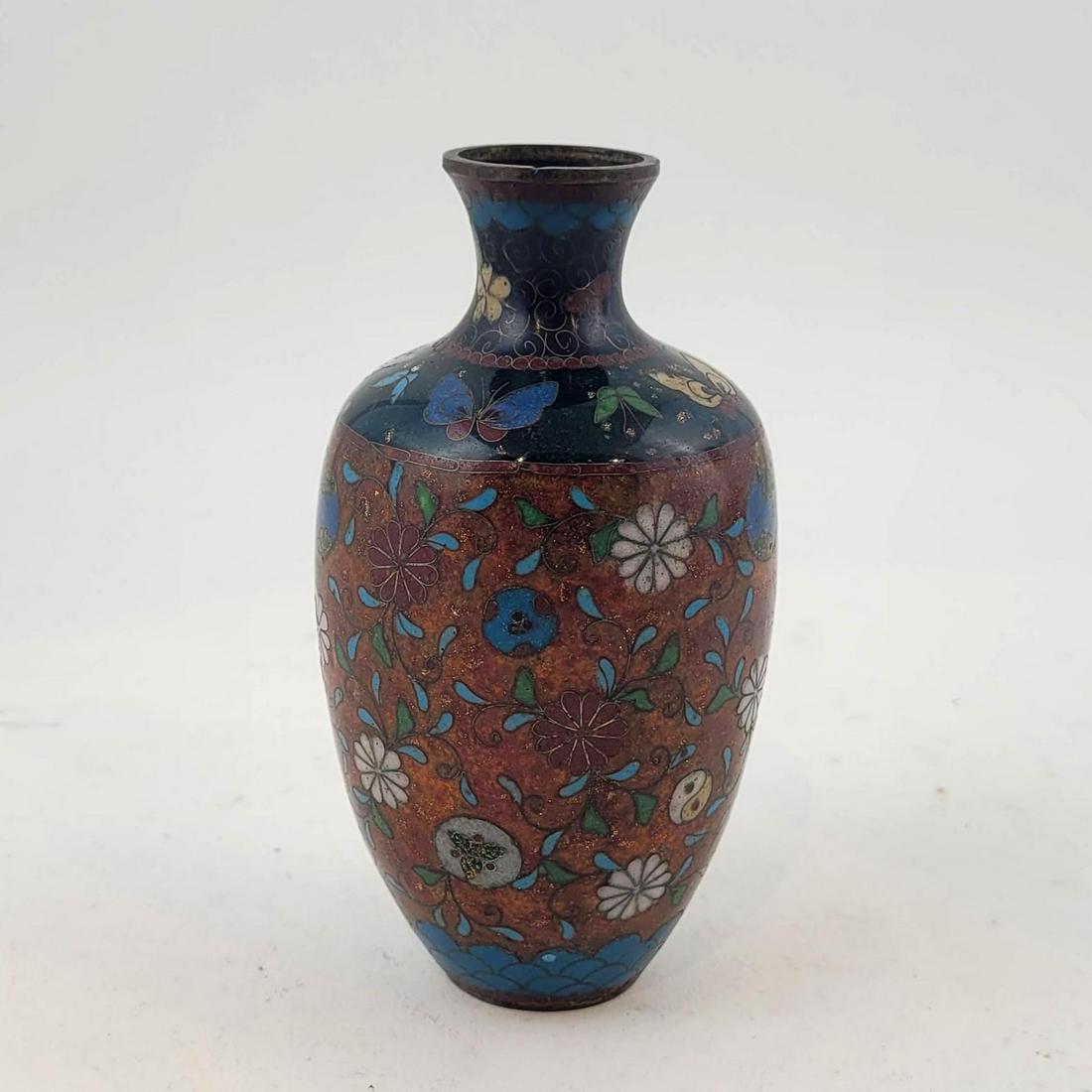 Japanese Enamel on Cloisonne Vase: Antique Japanese enamel and cloisonne vase decorated with butterflies and floral motifs. Meiji period. Height: 5 inches. Property from the estate of Dr. Nafis Sadik, no reserve.