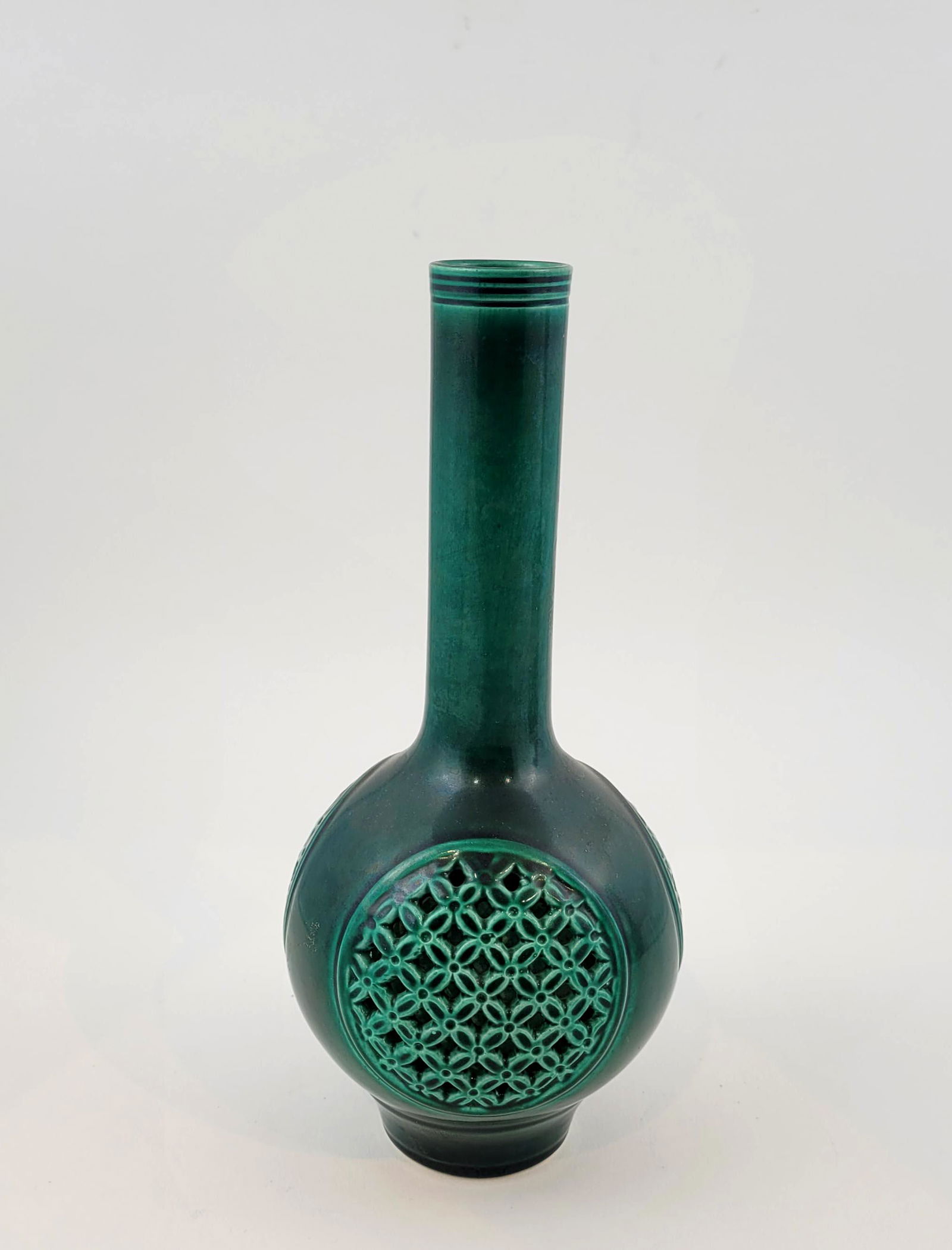 Chinese Green Glazed Porcelain Vase.: Chinese porcelain bottle with slender neck and carved openwork to body. Green glazed. Height 9 1/2 inches. Property from the estate of Dr. Nafis Sadik, no reserve.