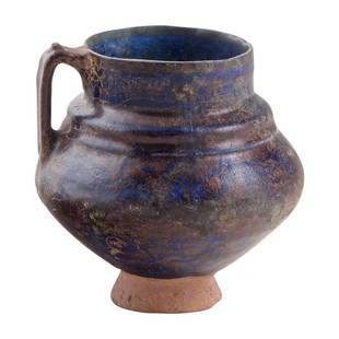 Kashan Cobalt and Luster Glazed Pottery Jar: Luster decorated cobalt blue pottery jar with handle, Iran 12th-13th century AD. 7 x 6 x 6 inches