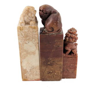 Three Chinese Stone Stamp Seals: Three Chinese stone stamp seals. All with carved lion tops. Smaller one is 2.75 inches tall. Larger ones are both 3.8 inches tall.