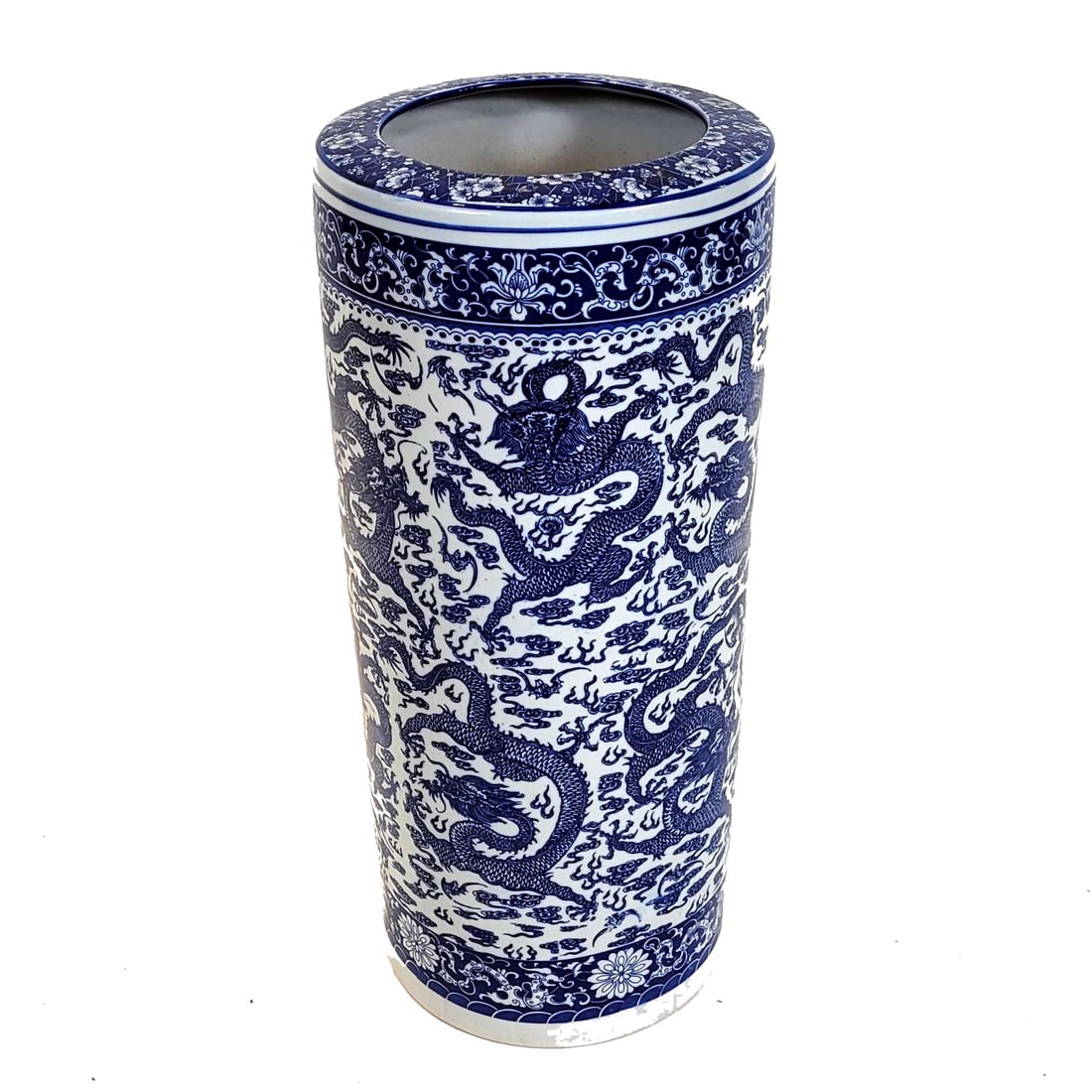 Chinese Porcelain Umbrella Stand: A Chinese blue and white porcelain umbrella stand with dragon motif. Height 24 1/2 inches. Diameter 10 1/2 inches. Property from the estate of Dr. Nasif Sadik, no reserve.