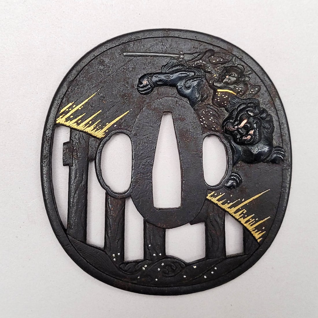 Japanese Tsuba: Mixed metal on iron. Includes man riding. Meiji period. 3.35 x 3.25 inches.