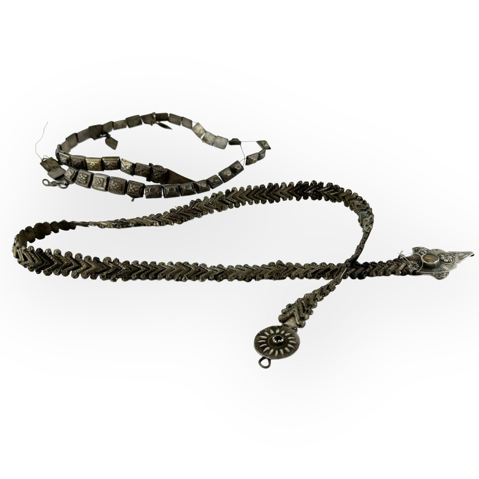 Lot of Two Caucasian Silver Belts: Lot of two Caucasian silver belts. 19th century. One belt is missing some square pyramid-shaped beads and part of wire. Dimensions: 33 inches (of longest one).