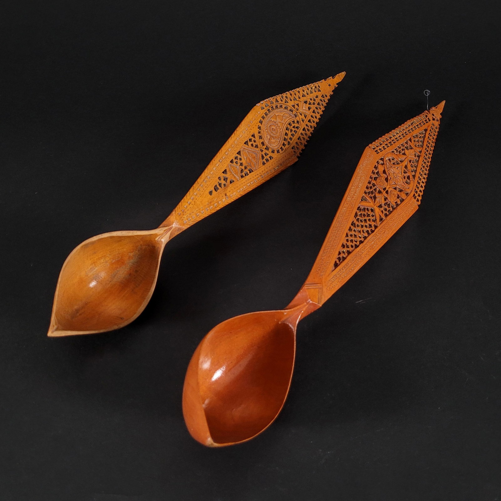 Two Qajar Persian Fruitwood Soup Ladles: Two Qajar Persian fruitwood soup ladles. One ladle handle has carved floral openwork designs while the second has a carved boteh leaf. 19th century. Dimensions: 16 1/2 x 2 1/2 x 2 inches (one ladle).