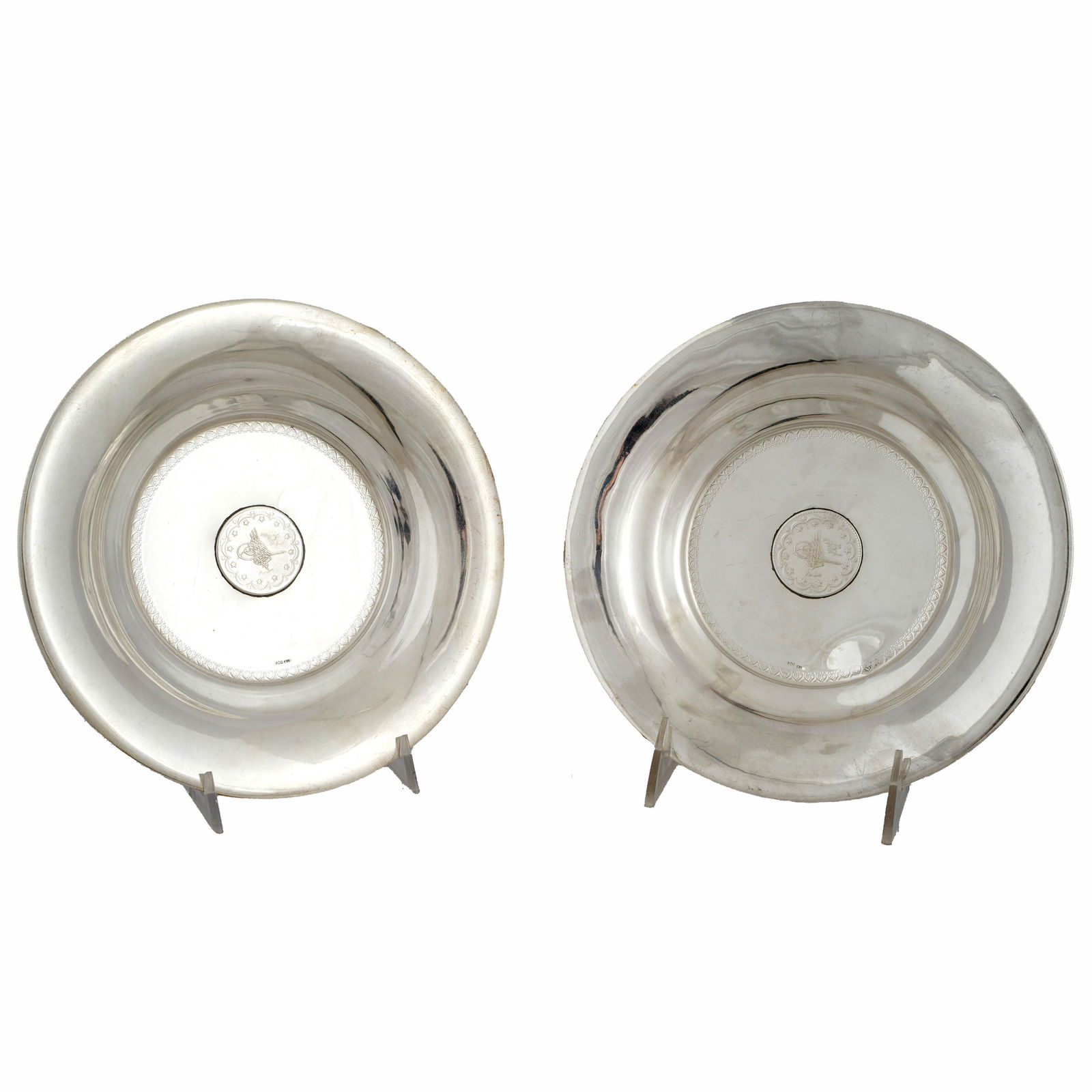Lot of Two Ottoman Turkish Silver Coin Dishes: Lot of two Ottoman Turkish silver coin dishes. The dishes have coins bearing the Tughra of an Ottoman Sultan inset into their wells. The dish is marked 800 silver and the coin is dated 1292 Hijri (187