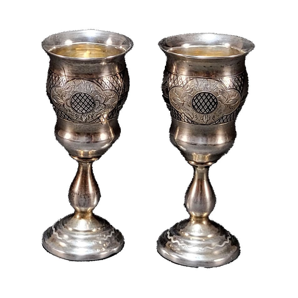 Pair of Russian Niello Silver Vodka Goblets: Pair of Russian niello silver vodka goblets. The bowls of these ryumki are adorned with niello lattice pattern, and further designed with medallions depicting rustic Russian villages and radiating sun