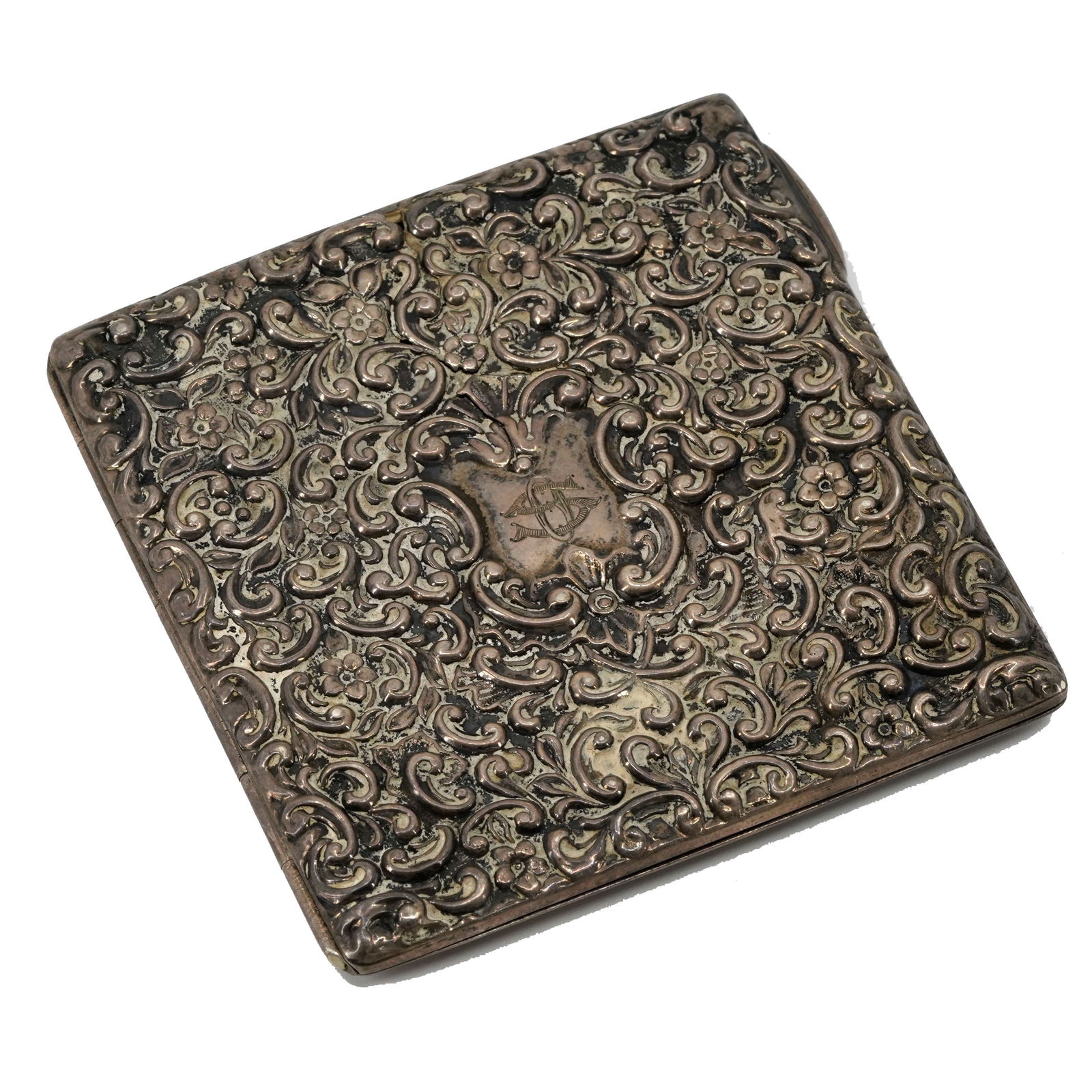 Ottoman Silver Cigarette Case: Ottoman silver cigarette case. The case is covered in repouss?? floral and vine arrangements. Monogrammed for export market. Minor crack and torn band on the inside. Late 19th century. Dimensions: 3