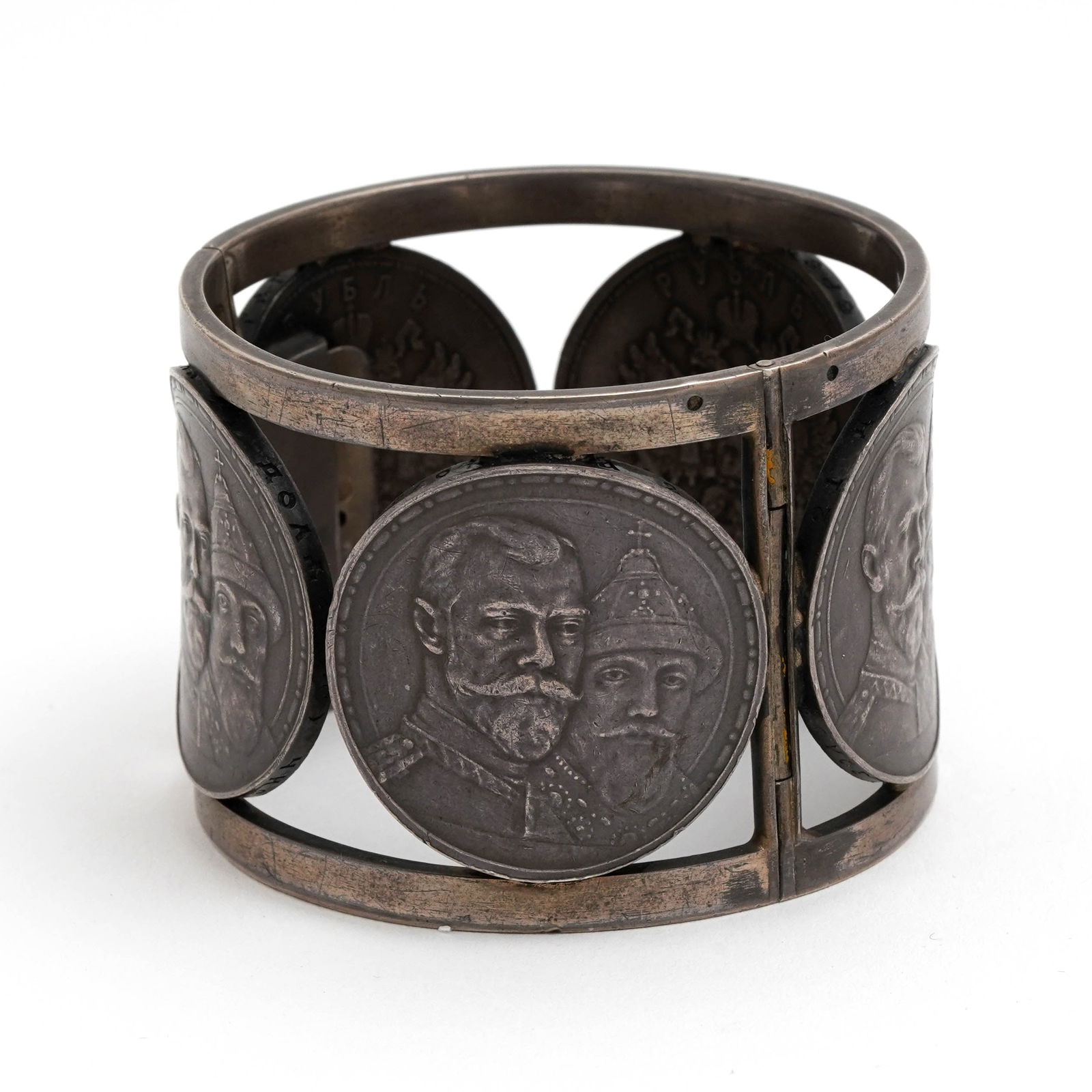 Russian Silver Coin Cuff Bracelet: Russian silver coin cuff bracelet. The bracelet is composed of five silver House of Romanov ruble coins. Dimensions: 2 1/4 x 1 3/4 inches.