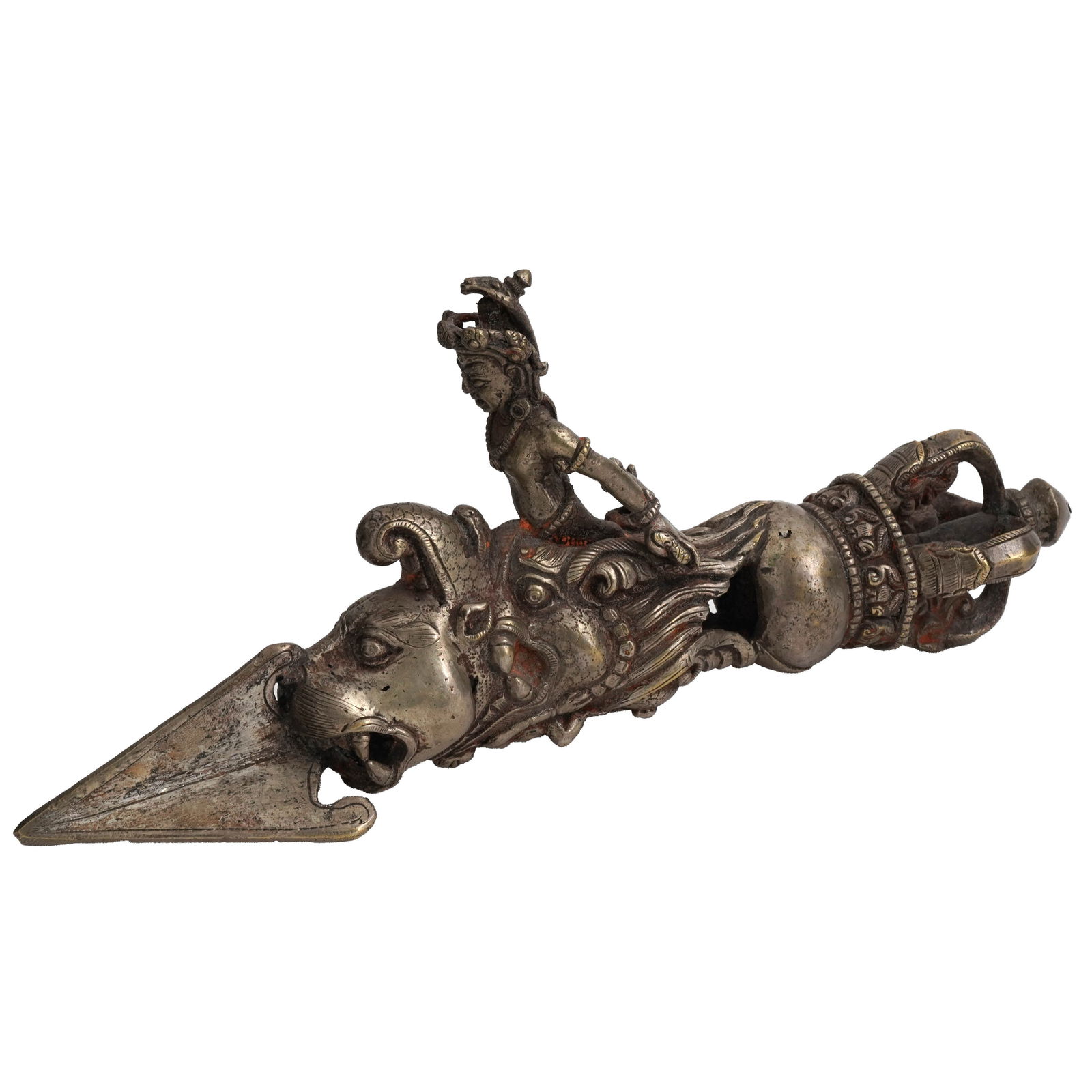 Tibetan Metal Phurba Dagger: Tibetan metal Phurba dagger. This dagger has a crown pommel, a traditional three-sided blade, and depicts a Bodhisattva riding a beast on its handle. The piece has red deposits in its crevices. Dimens
