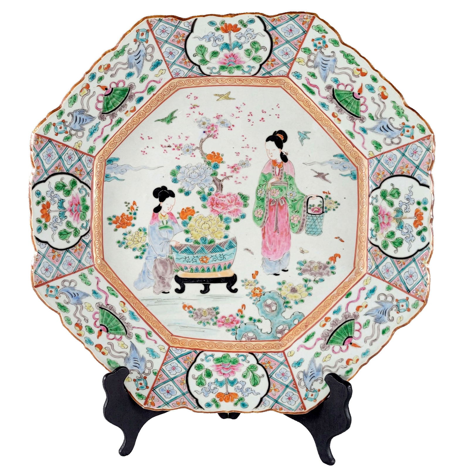 Japanese Famille Rose Chinese Market Porcelain Charger: Japanese eight-sided famille rose porcelain charger plate. Made for the Chinese market. On the face of plate two maidens in kimonos lounge in a floral garden. Intact. Dimensions: 17 x 2 1/2 inches.