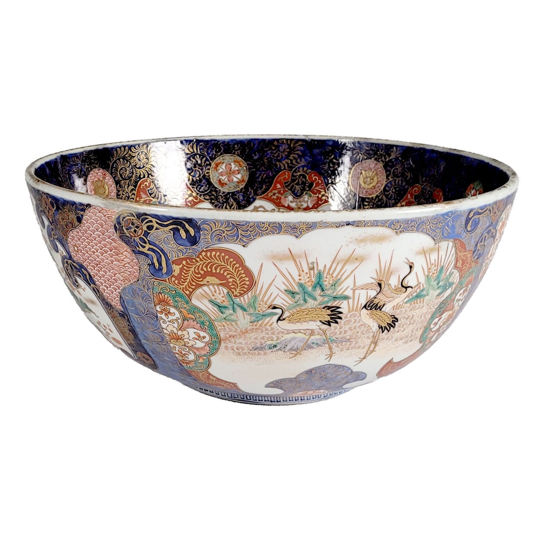 Japanese Imari-ware Porcelain Bowl with Garden Motifs: Japanese Imari-ware enamel porcelain bowl. The interior has finely detailed motifs of flowers, scrolling vines, and rabbit medallions. The exterior depicts lush garden scenes. Ocean and sunset color p