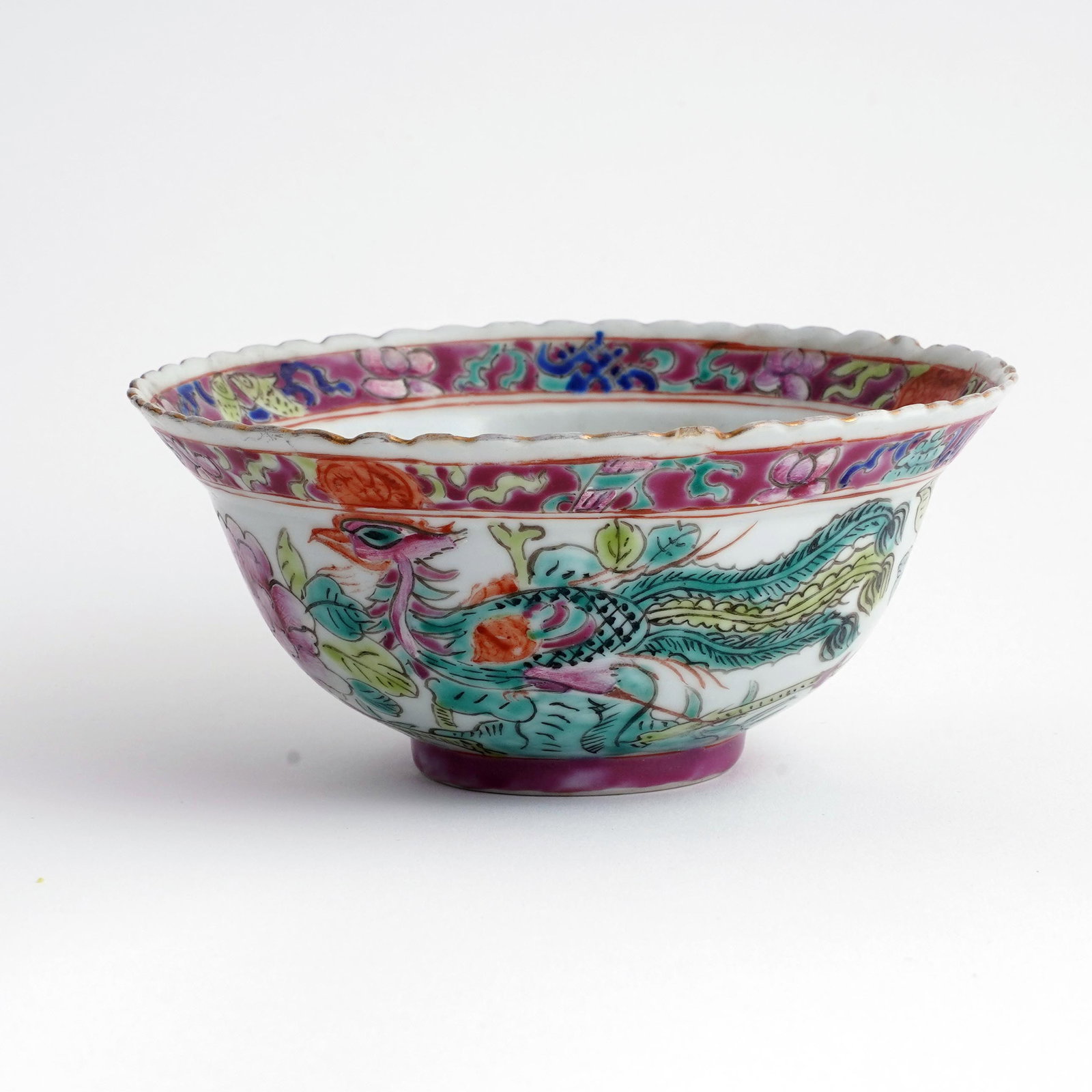 Chinese Famille Rose Porcelain Bowl: Chinese famille rose porcelain bowl, decorated with phoenix birds and floral sprays beneath a pink-ground border, scalloped rim, underside with iron-red apocryphal Qianlong seal mark. H:2 1/2 x D: 5 1