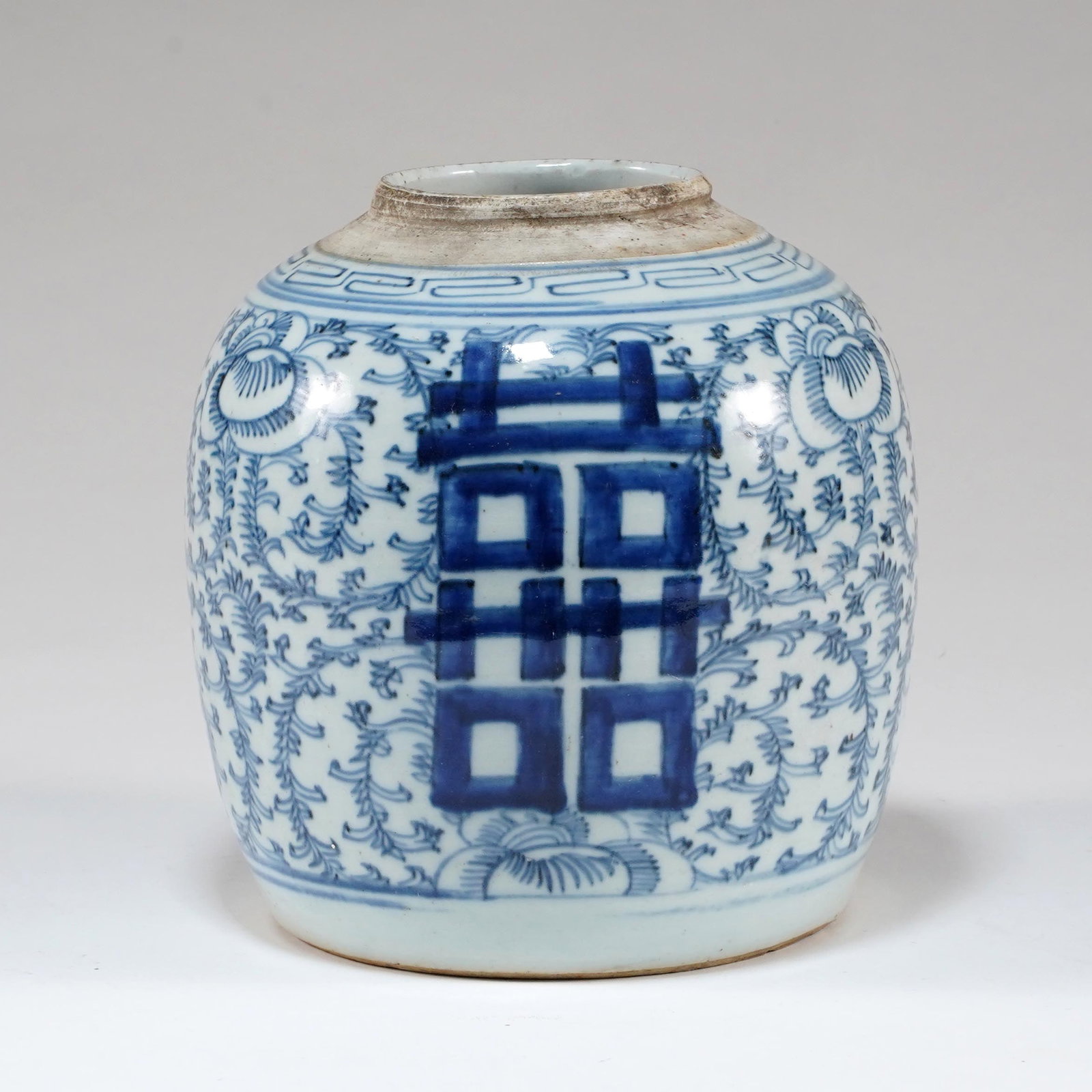 Chinese Blue and White Porcelain Double Happiness Jar: Chinese blue and white porcelain double happiness jar, ovoid form, decorated with large shuangxi characters, floral scrollwork, and key-fret border.. H: 8 1/2 x D: 7 3/8 in.