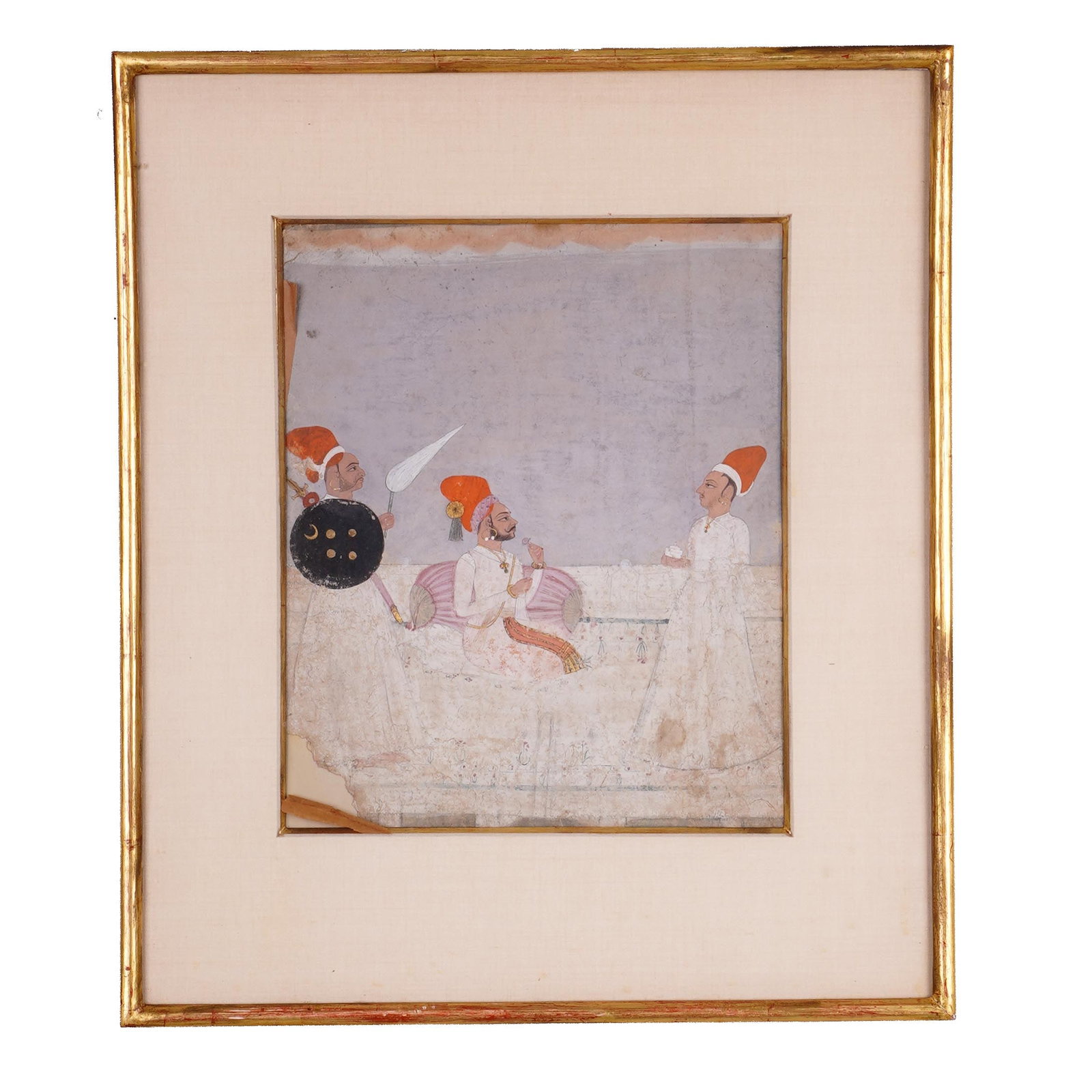 Framed Indian Court Scene Miniature Painting: An Indian miniature painting depicting a seated nobleman or ruler receiving attendants, with a shield-bearing guard at left and a standing attendant at right. Gouache and ink on paper, with pale archi