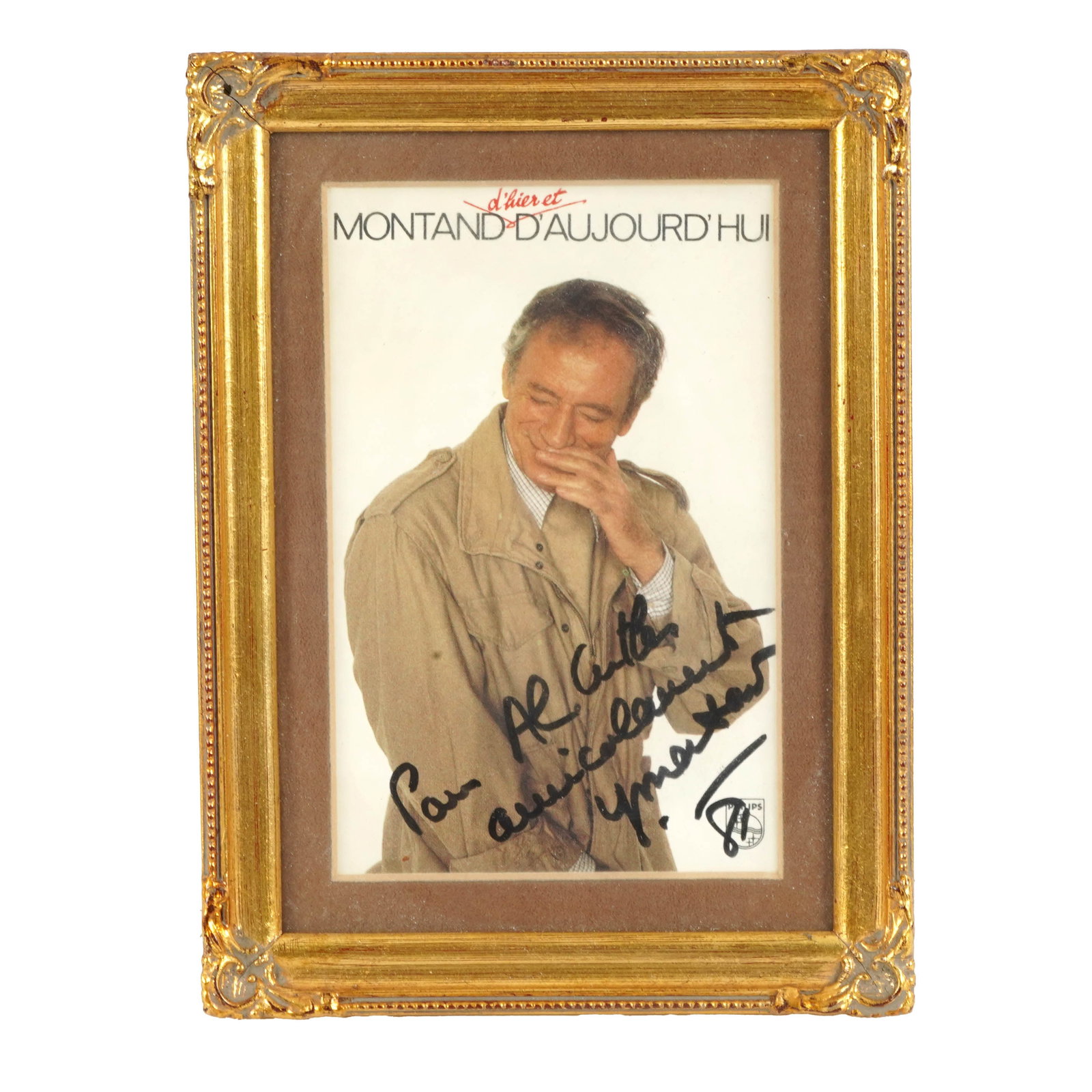 Signed “Montand d’Aujourd’hui" Publicity Photograph: Framed color publicity photograph or book-cover image titled “Montand d’Aujourd’hui,” with large black marker inscription and signature across the lower portion. Matted and framed under gl
