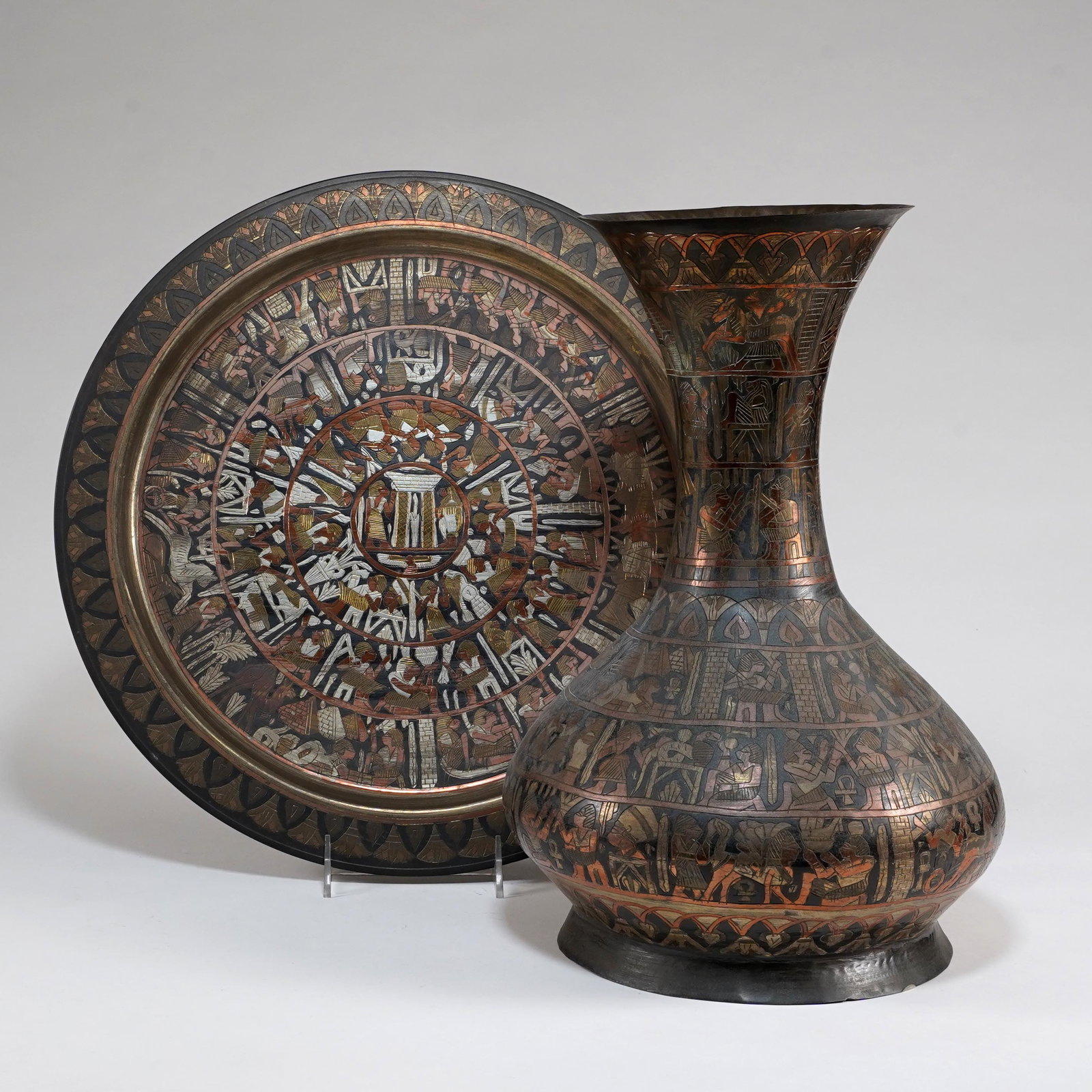 Egyptian Revival Mixed Metal Vase and Charger: Egyptian Revival mixed metal vase and charger, decorated with inlaid and engraved Egyptian-style figural scenes, hieroglyphic motifs, animals, and lotus borders. Size for vase: H: 15 x D: 9 1/2 in., S
