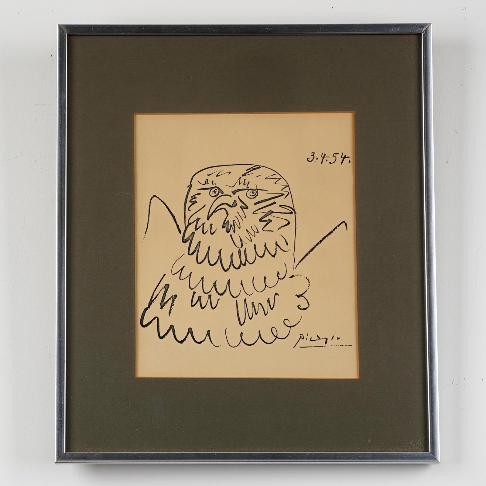 Pablo Picasso Bald Eagle Print: A framed Picasso print of a bald eagle, rendered with loose black linework. The print is dated upper right “3.4.54” and bears a Picasso signature lower right. Presented under glass with olive