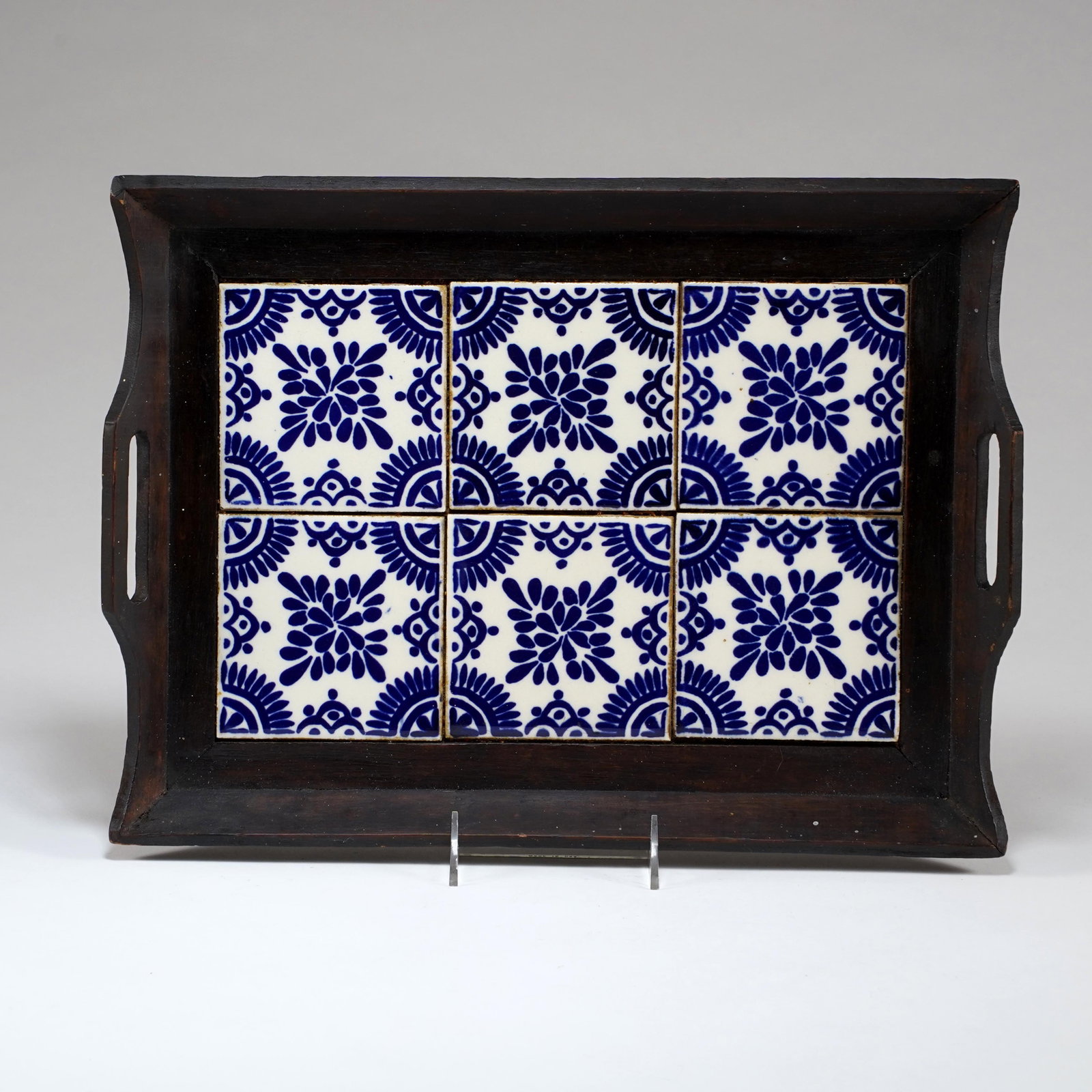 Mexican Tile-Top Wooden Serving Tray: Mexican tile-top wooden serving tray, inset with six blue-and-white ceramic tiles in a repeating floral Talavera-style pattern, with dark stained wooden frame and cut-out side handles. H: 1 1/8 x L: