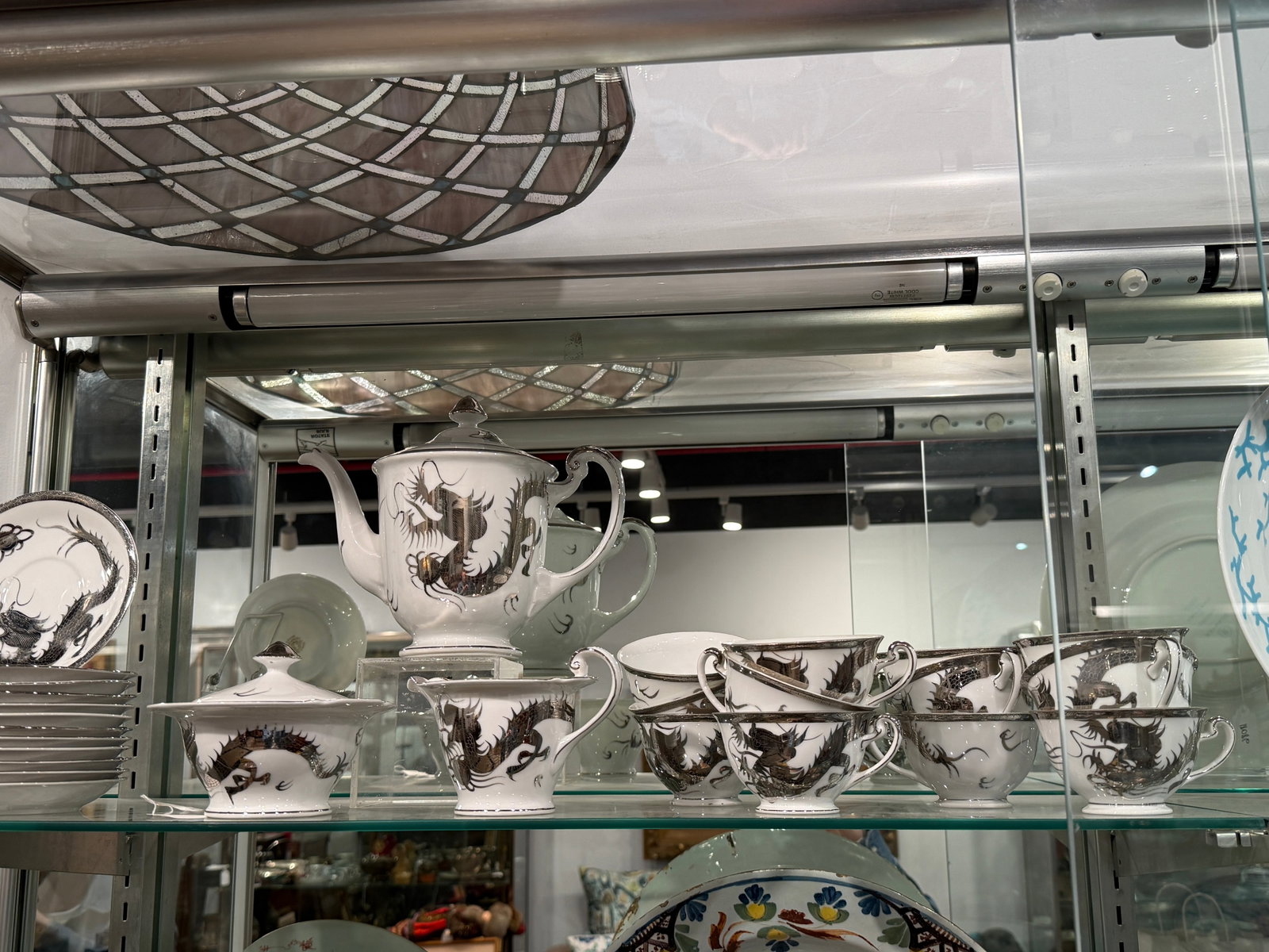 Silver Inlay Dragon Chinese service for 12. Japanese porcelain.: Coffee service for 12. Japanese porcelain with a dragon motive. Marked HAyasi China Handpainted Japan. Size for saucer: H: 3/4 x D: 5 5/8 in. Size for teapot : H:7 1/2 x : 9 1/4 x D: 5 1/4 in. Propert