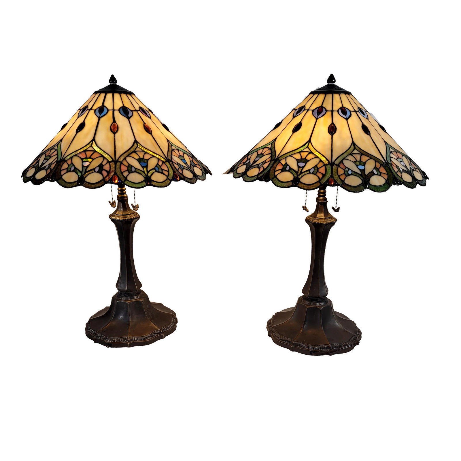 Pair of Tiffany-style Table Lamps: Tiffany-style slag glass table lamps featuring a bronzed finish and conical stained glass shade with intricate floral and geometrical patterns. Art deco style. 30" H x 22" W