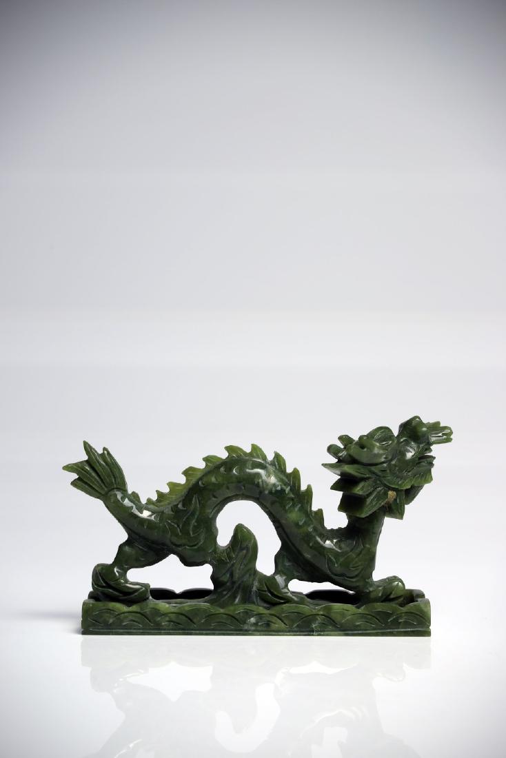 Dragon: Jade China 20th ct L: 15 cm A Chinese dragon in motion with opened mouth, standing on a cloud, his body shaped like a wave.