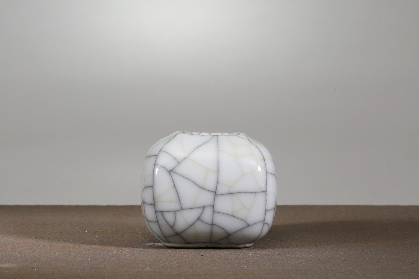 SQUARE WATER JAR: Ge glazed China , Qian long, Qing dynastyDimensions: Height 4,5 cmWeight: 80,1 gramsGe glaze's characteristic is the cream or ivory color with crackles. But also colors ranging from grey to brown with