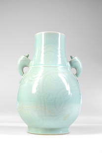 LIGHT BLUE GLAZED DOVE-EAR VASE: Xuan He mark China , Qian Long period (1711-1799), Qing Dynasty Dimensions: Height 26 cm by 17 cm Weight: 1649,5 grams Vase with dove-ears in light blue with ornamental pattern. Cracked and