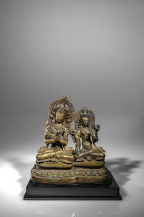 GROUP OF VAJRADHARA AND WHITE TARA: Bronze firegilt Nepal, about 1850 Dimensions: Height 19,5 cm Wide 20 cm Depth9 cm Weight: 1955 grams without base This is a pair of Buddha Vajradhara and a White Tara seated in unison on a large