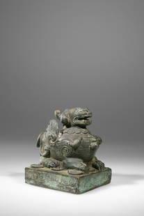 SEAL OR OPIUM WEIGHT: Bronze China , 18th century Dimensions: height 10,5 cm Depth 10 cm Wide 8 cm Weight: 795 grams A seal or opium weight in shape of a foo dog standing on a rectangular base. Foo dogs are winged