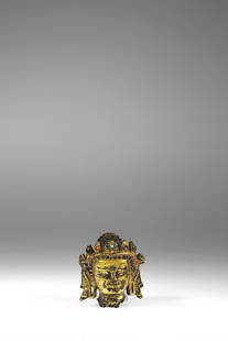 HEAD OF A CROWNED BUDDHA: Bronze fire gilt with turquoise und semi precious stones Nepal , 14th century Dimensions: Height 4 cm Weight: 96 grams Small broken head of a Buddha with five-pointed tiara with stone inlay in two