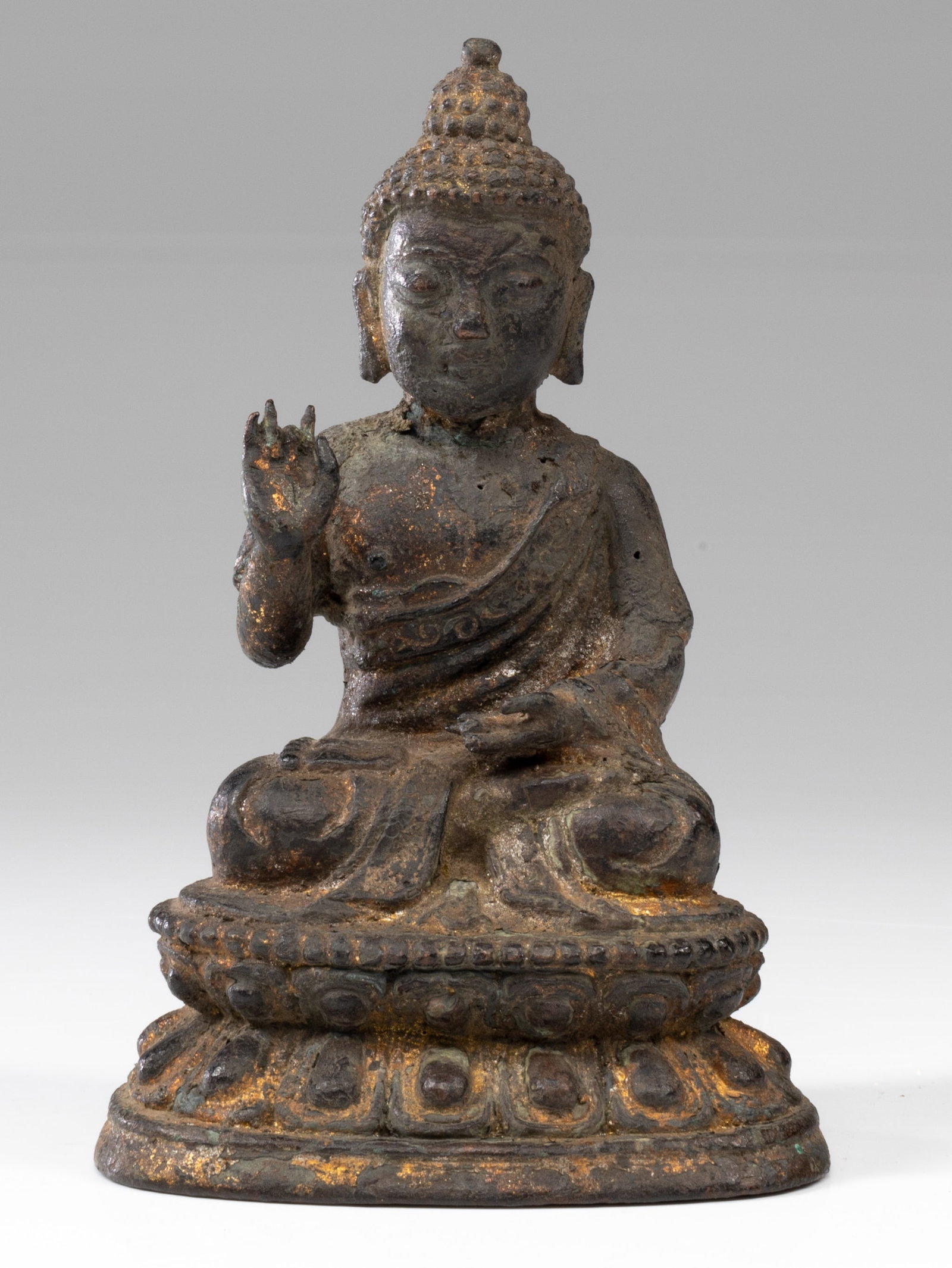 BUDDHA: Bronze China , Ming Dynasty (1368-1644) Dimensions: Height 16 cm Width 10 cm Depth 8 cm Weight: 903 grams Seated Buddha on lotus base with beaded rim, with legs crossed and dressed in a robe with orna