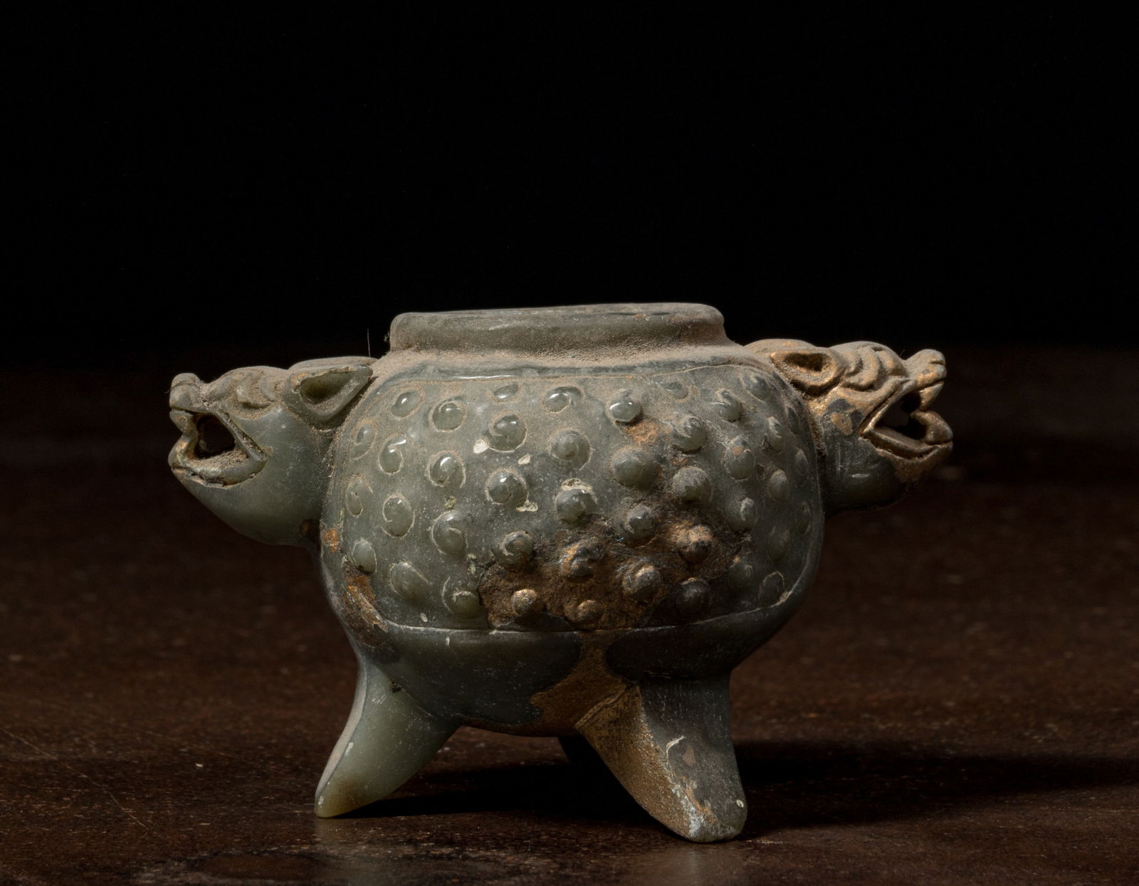 JADEITE OFFERING BOWL CHINA 4TH CENTURY: Dimensions: Height 5,5 cm Wide 9 cm Depth 5,5 cm Weight: 165 grams The vessel is finely carved from deep green jadeite with a globular, raised-dot surface pattern, supported on three short legs. The b