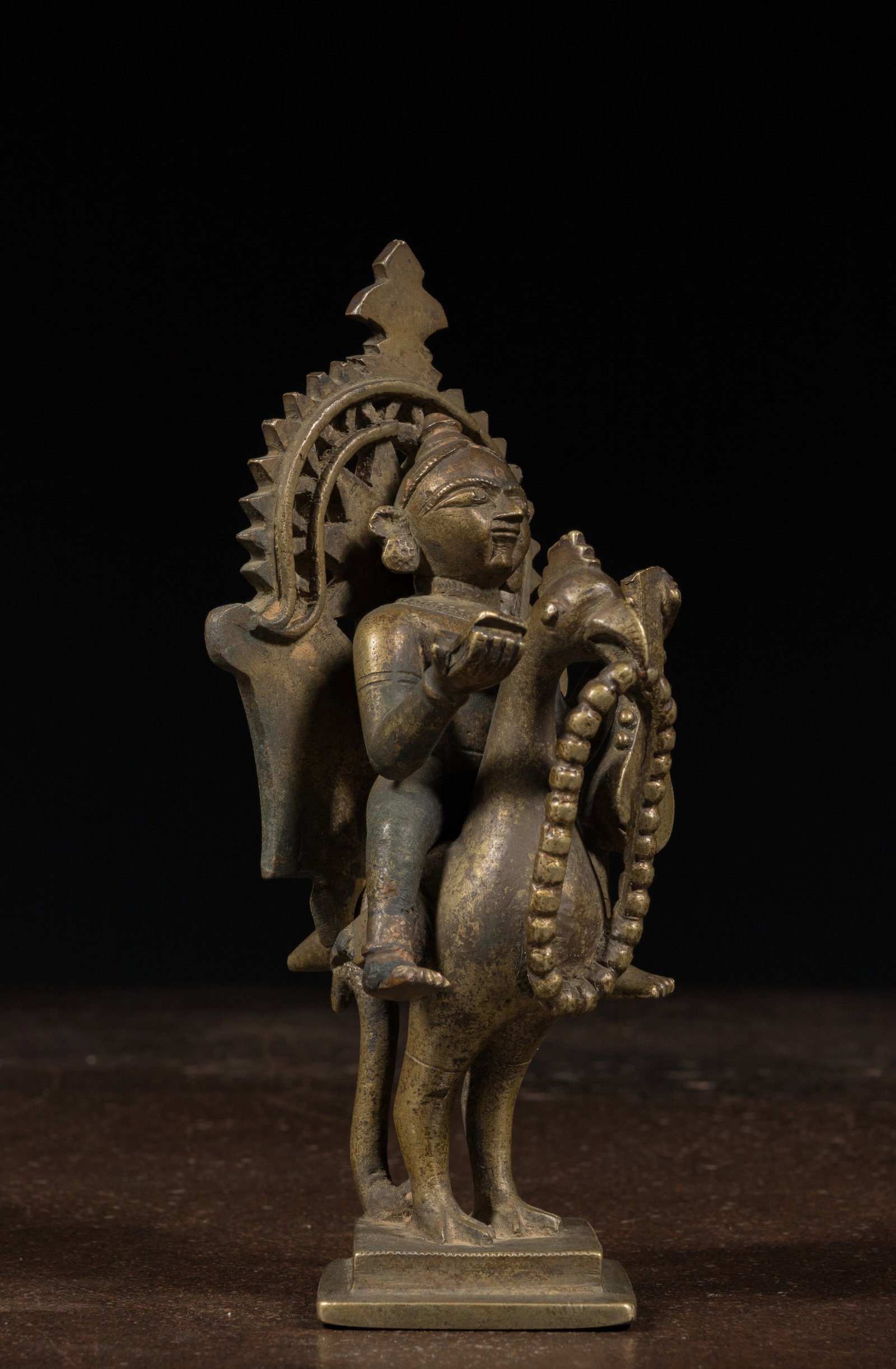 SARASWATI ON A SWAN BRONZE INDIA 19TH CENTURY: Dimensions: Height 17 cm Wide 7,5 cm Depth 8 cm Weight: 890,9 grams Saraswati rides upon her vahana or vehicle, a swan. She plays her instrument, the veena. Her ride hand holds a copy of the vedas. Th