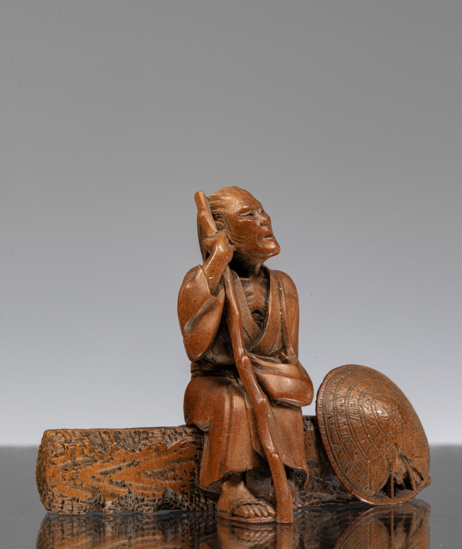 NETSUKE OF A SEATED PILGIRM (1 of 6)