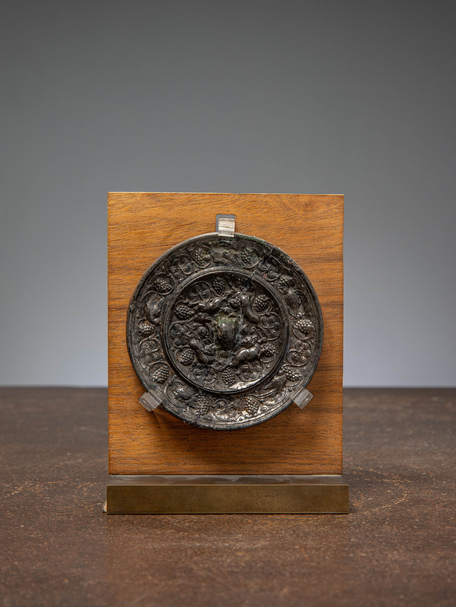 (R) A BRONZE MIRROR WITH ANIMALS AND GRAPEVINES, TANG DYNASTY, CHINA 7TH TO 8TH CENTURY (1 of 2)